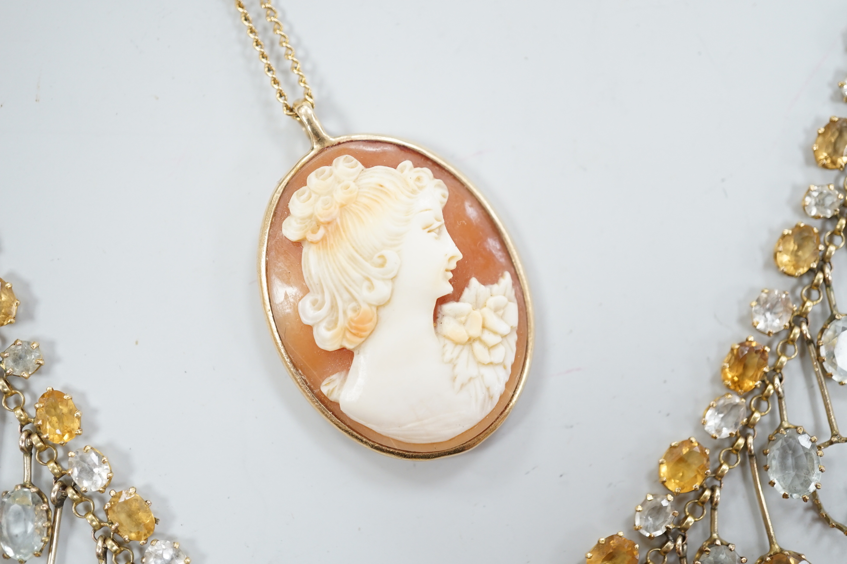 A yellow metal mounted oval cameo shell pendant, on a 9ct chain, together with a citrine and colourless beryl? set drop fringe necklace(a.f.).
